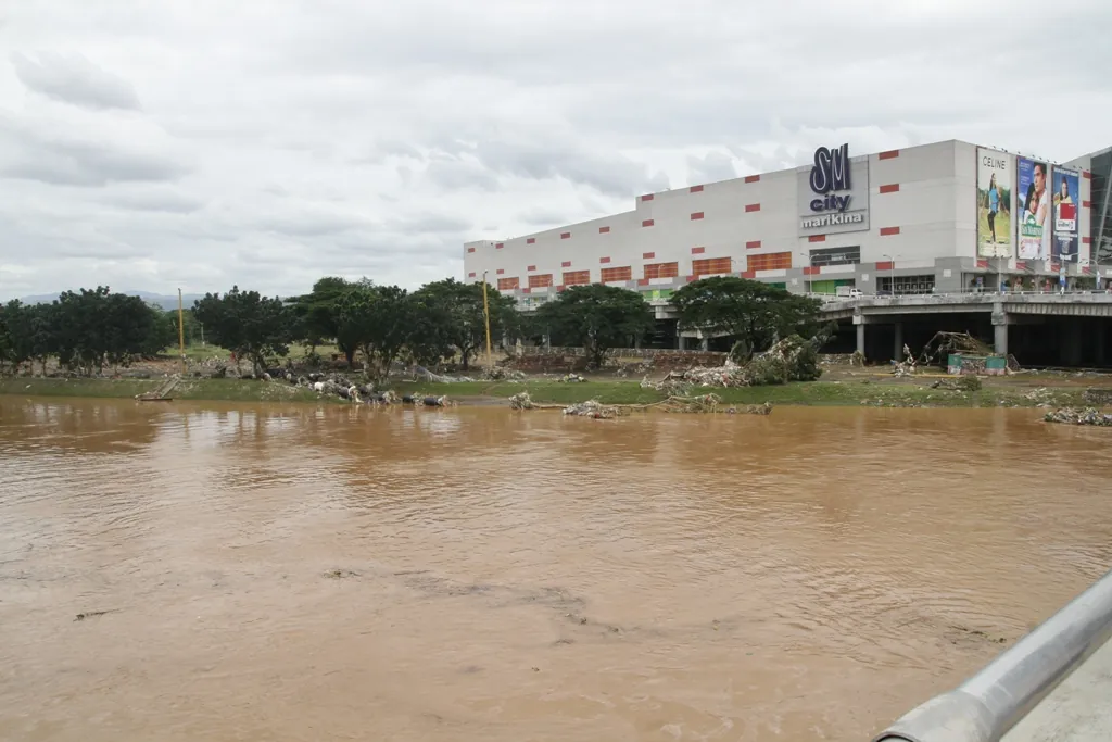 The swollen river beside a riverside mall the day after the flood, 27 September 2009